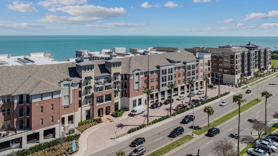 the beach and ocean from an aerial view of a condo building at The  Alexa