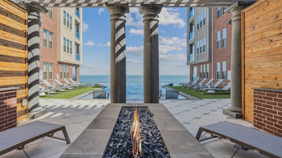 the patio has a fire pit and lounge chairs at The  Alexa