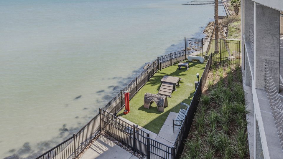 a view of the beach from a balcony overlooking the water at The  Alexa