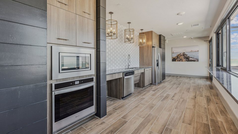 a kitchen with wood floors and stainless steel appliances at The  Alexa