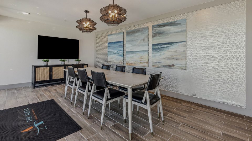 a conference room with a large flat screen tv and a table at The  Alexa