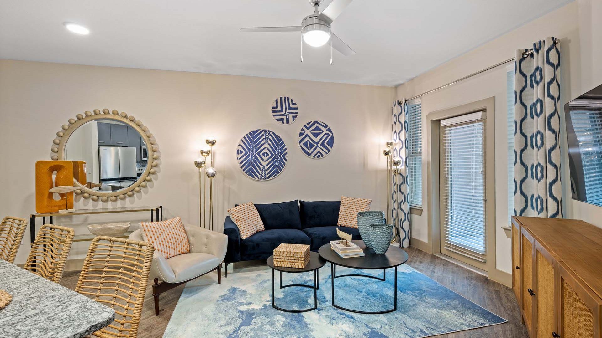 a living room with a blue ceiling fan and blue walls at The Alexa